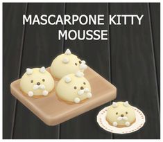 three cupcakes with white frosting are on a wooden tray and the words mascarpone kitty mouse is above them