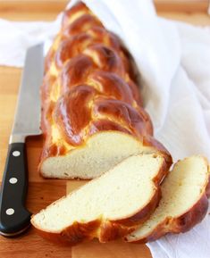 a loaf of bread sitting on top of a cutting board next to a knife