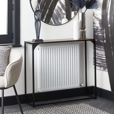 a white radiator sitting on top of a wooden table next to a chair