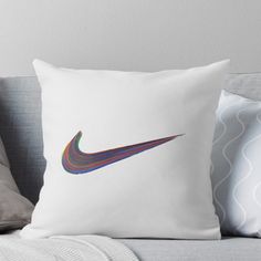 a colorful nike logo on a white background throw pillow