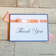 a thank you card with an orange ribbon on it