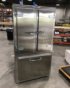 two stainless steel refrigerators in a warehouse