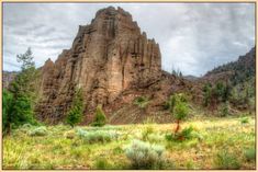 a large rock formation in the middle of a field