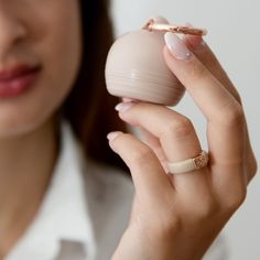 a woman is holding an object in her hand