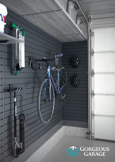 there is a bike hanging on the wall next to it's storage rack in this garage