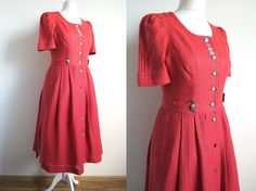 "Vintage German summer dress by MEICO Landhaus Look.. Coral red linen, solid weave in the top part and striped texture on the skirt. The dress got short puffed sleeves and full midi skirt with side slits. There are pin-tuck details on the sleeves, shoulders and the adjustment sashes. Buttons down the front with silver tone round metal buttons. There are also oval metal deco plates with edelweiss flowers stitched between the top two buttons. The dress got side pockets! Lining goes from the waist down. Estimated size Medium. Please check the measurements below: armpit  ~ 94 cm /  ~ 37 \" waist  ~ 78 cm  /  ~ 30 \" length  ~ 110 cm  /  ~ 43 \" In great vintage condition." Summer Gown, Bavarian Dress, Oktoberfest Dress, Summer Gowns, Boho Pullover, Full Midi Skirt, Loose Fit Blouse, Dirndl Dress, Style Cottage