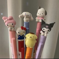 several hello kitty pens are lined up in a holder