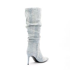 a pair of high heeled shoes on top of a white surface with the bottom part covered in fabric