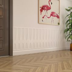 a pink flamingo painting hanging on the wall next to a potted plant in an empty room