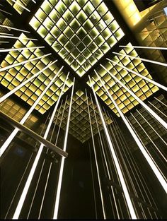 an image of a very tall building with many lights on it's sides and the ceiling