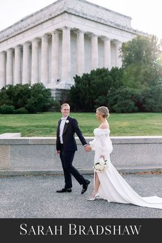 a bride and groom holding hands in front of the lincoln memorial