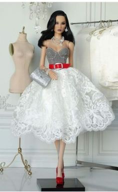 a barbie doll dressed in a white dress and red shoes