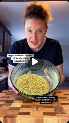 a woman holding a glass bowl filled with food