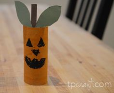 a paper tube with a leaf sticking out of it