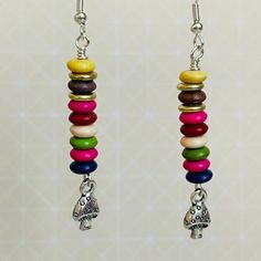 a pair of earrings with colorful beads hanging from them