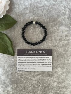 "Black onyx bracelet, Black onyx is a powerful protection stone that works to absorb negative energy. It aids in the healing of past pain, giving one the courage to start a new journey. I have hand made this lovely bracelet with 6mm beads and made to size 6\" length The bracelet also comes with the card as pictured showing the meaning of the stone If you require a different size please message and I will, try and help. ❤️ (Not suitable for under 3 years of age)" Black Gemstone Beads Stretch Bracelet Gift, Black Stretch Bracelet With Gemstone Beads For Gift, Adjustable Onyx Bracelet For Healing, Adjustable Onyx Stretch Bracelet For Healing, Adjustable Black Stretch Bracelet For Meditation, Handmade Black Crystal Bracelet In Spiritual Style, Handmade Black Crystal Bracelet For Spiritual Purposes, Black Spiritual Beaded Bracelets As Gift, Spiritual Black Beaded Bracelets As Gift