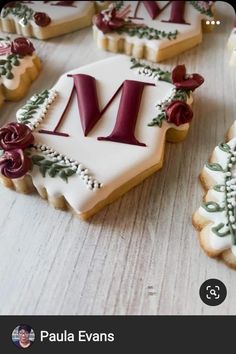 decorated cookies with the letter m on them sitting on a table next to each other