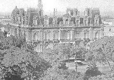 an old black and white photo of a large building with trees in front of it