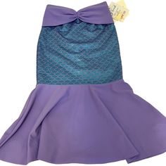 This Adorable Lavender & Teal Scale Print Fold-Over Mermaid Tail Skirt Is The Perfect Children's Swimwear, As It Is Sized Specifically For Kids And Will Grow With Your Child For Years To Come! The Mermaid Tail Lycra Fabric Provides Spf 50+ Protection And Is Made For Summer Water Activities. The Bright & Shiny Foil Printed Skirt Is Easy To Slide Over A Bathing Suit When On The Go With The Fold-Over Elastic Waistband. The Lycra Covered Stretch Waistband Makes The Skirt Expandable, To Make His/Her Fitted Mermaid Dress For Beach In Summer, Fitted Mermaid Dress For Beach Summer, Fitted Mermaid Dress For Summer Beach, Summer Beach Mermaid Dress, Fitted Purple Swim Skirt For Summer, Fitted Mermaid Dress For Beach, Blue Mermaid Dress For Summer, Purple Sleeveless Mermaid Dress For Summer, Purple Mermaid Dress For Summer