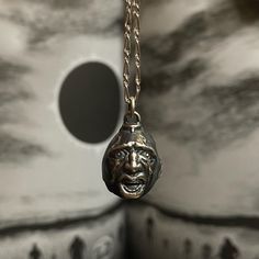 a close up of a metal object on a chain