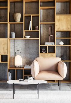 Bookcase and armchair illuminated by Woud Ghost Table Lamp. Ghost Table, Living Room Lamp, Designer Studio, Sofa Legs, Contemporary Table Lamps, Classic Sofa, Room Lamp, Soft Seating, White Table Lamp