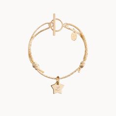 A meaningful gift with colorful sparkle, our Personalized Sparkling Mini Charm Bracelet can be personalized to perfectly capture a special personality. Each braid adds a pop of colour and sparkle to every movement, perfectly matching your metal of choice. Engrave up to three mini charms to treasure with the names of loved ones and little to make your unique keepsake extra-special.&nbsp;18K Champagne Gold Plated, 925 Sterling Silver or 18K Rose Gold PlatedCharms: 0.4x0.4 (mini heart, disc or star)Fully adjustable sliding knot fastening with T-Bar claspHand-engraved in our Paris workshopSent with love in a complimentary gift boxAny slight variations in lettering depth, spacing and alignment from the examples shown are part of the aesthetic and originality of the piece Adjustable Yellow Gold Bracelet With Logo Charm, Gold Charm Bracelet With Star Charm As A Gift, Yellow Gold Bracelets With Logo Charm For Gifts, Yellow Gold Bracelets With Logo Charm As Gift, Adjustable Charm Bracelet With Star Charm For Everyday, Adjustable Jewelry With Logo Charm As Gift, Heart Disc, Mini Charm, Sliding Knot