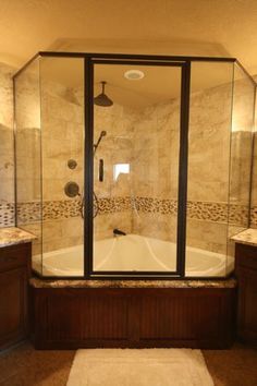 a walk in shower sitting next to a bath tub