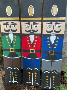 three wooden nutcrackers painted in different colors