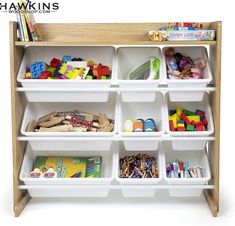 a toy shelf filled with lots of toys on top of white bins and wooden shelves