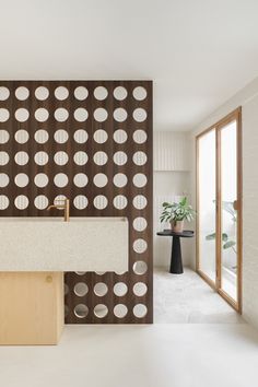 the reception table is made out of wood and has white countertop with circles on it