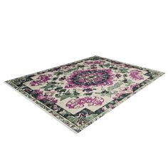 an area rug with pink and green flowers on the bottom, in front of a white background