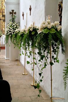 flowers and candles are lined up along the wall