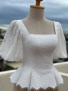 a mannequin wearing a white dress with short sleeves