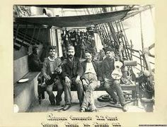 black and white photograph of men sitting on a boat