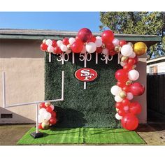 the football field is decorated with red, white and gold balloons for an nfl party