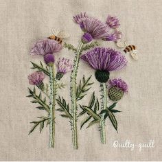 three purple flowers with bees on them are embroidered onto a piece of linen, which has been stitched together