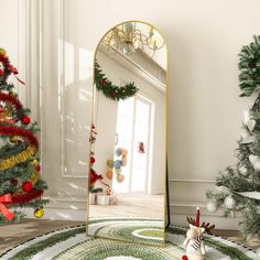 a mirror sitting on top of a rug in front of a christmas tree with decorations