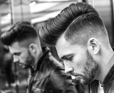 a black and white photo of a man with a pomp undercut wearing a leather jacket