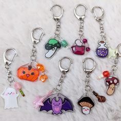 six different key chains with cartoon characters on them, all in various shapes and sizes