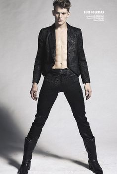 a shirtless man in black pants and boots posing for a magazine cover with his shirt open