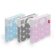 three different colored binders with the same pattern on them, one in pink and one in blue