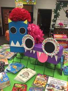 a table topped with lots of children's books and crafts on top of it