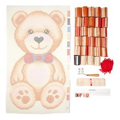 a teddy bear is next to some crochet stitches and threads on a white background