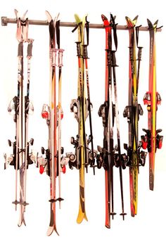 there are many skis hanging on the wall