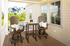 two chairs and a table on a porch