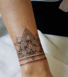 a woman's foot with a tattoo on it and a lotus flower in the middle