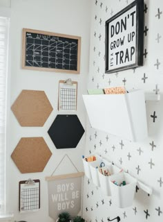 a white room with black and white wallpaper, wooden pegs on the wall