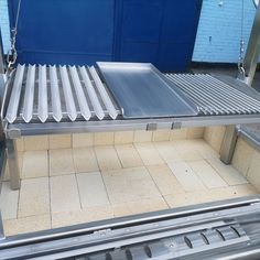 a metal shelf sitting on top of a tiled floor