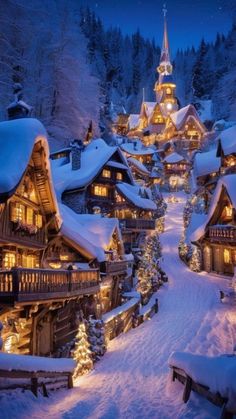 a snowy village with lit up christmas trees and lights on the houses in the snow