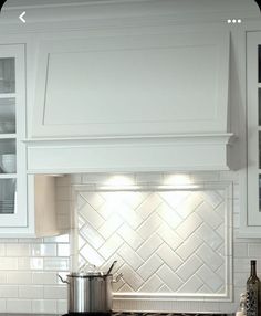 a stove top oven sitting inside of a kitchen next to white cabinets and counter tops